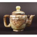 AN EARLY 20TH CENTURY CHINESE BOWENITE TEAPOT & COVER, the sides carved with panels of extended