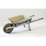 AN OLD RUSTIC WOODEN WHEELBARROW. 4ft 6ins long.