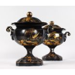 A GOOD PAIR OF 19TH CENTURY TOLEWARE TWO HANDLED URNS AND COVERS with Chinese type decoration in