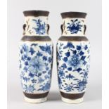 A PAIR OF CHINESE BLUE AND WHITE CRACKLE GLAZE VASES with birds, insects and flowers. 12ins high.