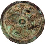 A SMALL CHINESE BRONZE MIRROR, possibly early, decorated in relief with birds and phoenix encircling