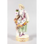 A GOOD MEISSEN FIGURE OF A YOUNG GIRL carrying a garland, on a circular base. Cross swords mark in