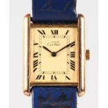 A LADIES CARTIER WRISTWATCH with blue leather strap.