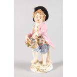 A SMALL MEISSEN FIGURE OF A YOUNG BOY holding a basket of flowers. Cross swords mark in blue.