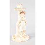 A ROYAL WORCESTER HADLEY STYLE CANDLESTICK FIGURE of a boy standing with his thumbs in his