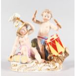 A GOOD MEISSEN GROUP, emblematic of war, with two cupids, one playing a drum. Cross swords mark in