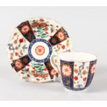 AN 18TH CENTURY WORCESTER FACETTED COFFEE CUP AND SAUCER painted in kakiemon style.