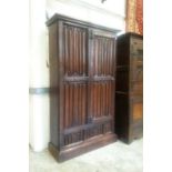 A GOOD 17TH CENTURY AND LATER LINEN FOLD CARVED OAK CUPBOARD with a single door on a plinth base.