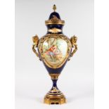 A GOOD SEVRES RICH BLUE TWO HANDLED URN AND COVER, edged in gilt with reverse panels painted with