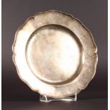 AN EARLY SILVER DISH with piecrust edge. 9.5ins diameter.
