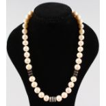 A STRING OF PEARLS with diamond sections.