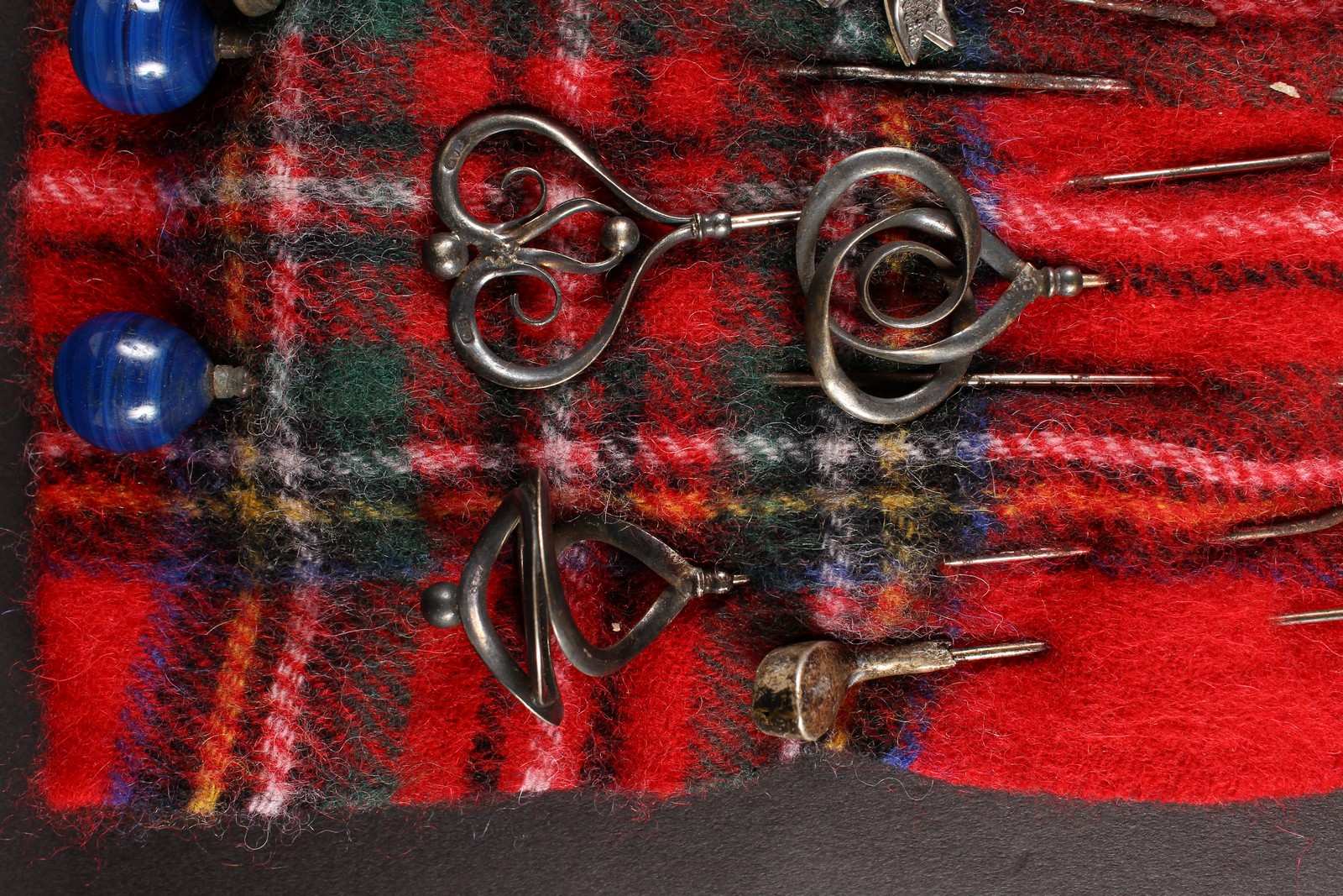 A COLLECTION OF FOURTEEN VICTORIAN AND EDWARDIAN HAT PINS on a tartan cloth. - Image 2 of 4