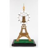 A GOOD EIFFEL TOWER BRASS SKELETON CLOCK with fusee movement, in a glass case. 2ft 3ins high.