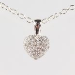 AN 18CT WHITE GOLD AND DIAMOND HEART SHAPED PENDANT AND CHAIN.