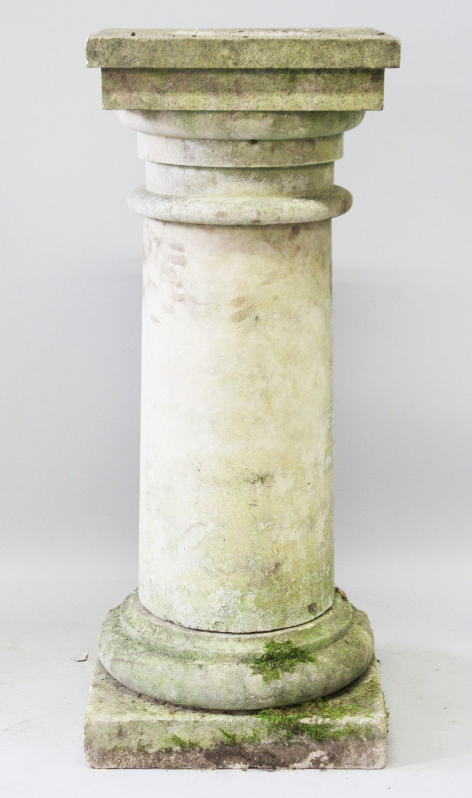 A PLAIN CIRCULAR PEDESTAL with square top and base. 3ft 8ins high, 1ft 5ins wide.