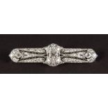 A GOLD ART DECO DIAMOND SET PLATINUM BAR BROOCH.