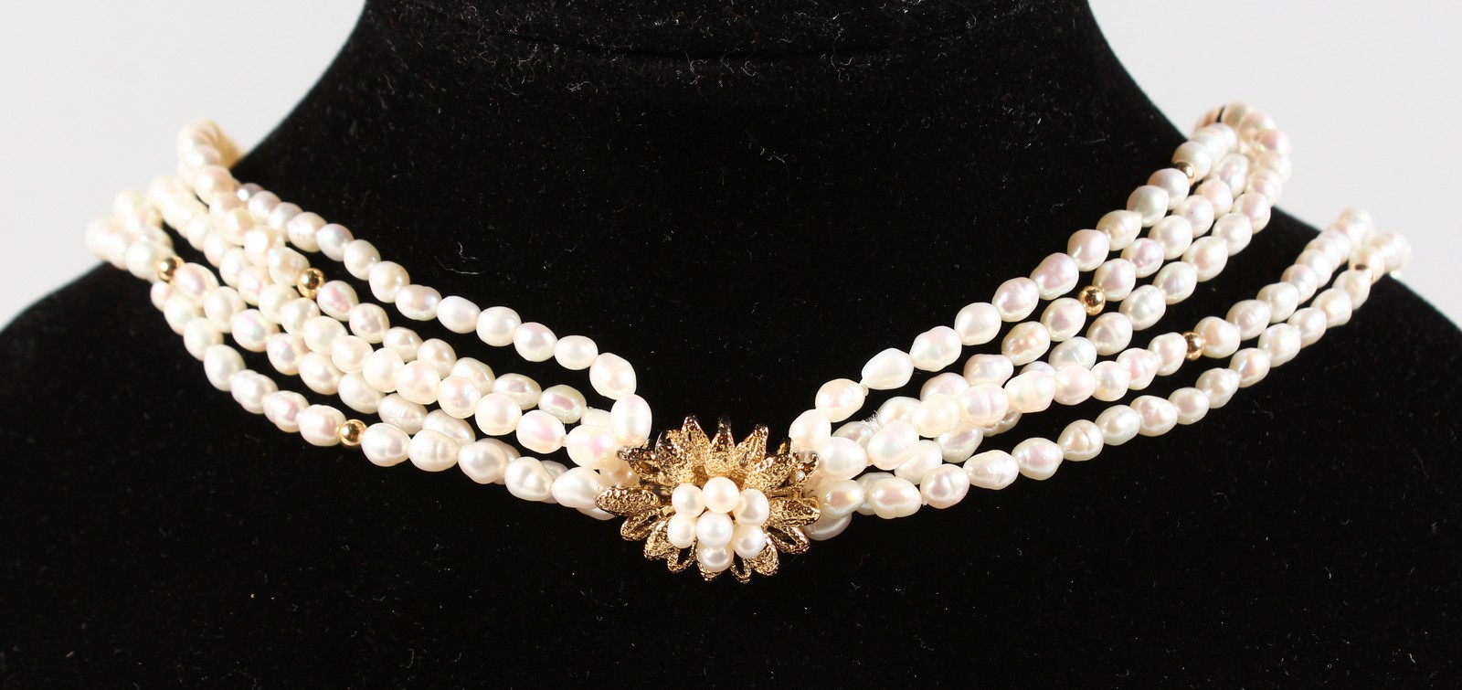 A THREE STRAND PEARL NECKLACE with silver clasp.