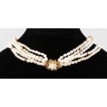 A THREE STRAND PEARL NECKLACE with silver clasp.