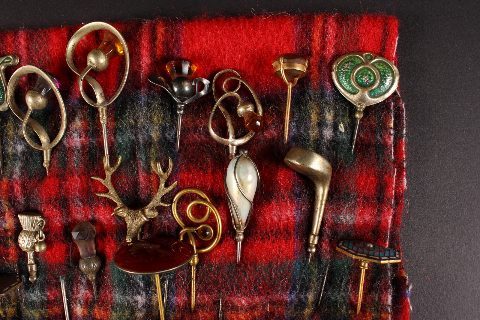 A COLLECTION OF SEVENTEEN VICTORIAN AND EDWARDIAN HAT PINS on a tartan cloth. - Image 3 of 4