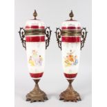 A GOOD PAIR OF FRENCH PORCELAIN METAL MOUNTED URNS AND COVERS, the body painted with classical