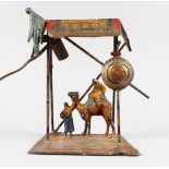 A BERGMAN STYLE COLD PAINTED SPELTER LAMP, modelled as Arab figure and a camel under a shelter. 9ins