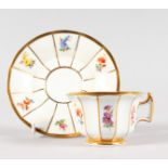 A SMALL MEISSEN CUP AND SAUCER, painted with vignettes of flowers. Cross swords mark in blue.