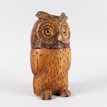 A BLACK FOREST STONEWARE OWL TOBACCO JAR with glass eyes. 10ins high.