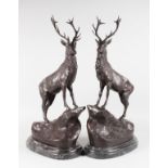 AFTER MOIGNIEZ A PAIR OF IMPOSING BRONZE STAGS, mounted on oval marble bases. 2ft 5ins high.