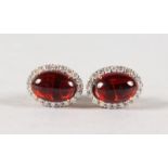 A PAIR OF 18CT YELLOW GOLD CABOCHON GARNET AND DIAMOND EARRINGS.