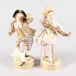 A GOOD PAIR OF MEISSEN FIGURES of A BOY AND GIRL carrying garlands and standing on circular bases.