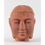 A CARVED TERRACOTTA HEAD. 10ins.