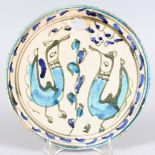 A FAIENCE CIRCULAR POTTERY WALL PLAQUE decoration with two birds. 8.25ins diameter.