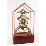 A VICTORIAN STYLE PIERCED BRASS AND GLASS SKELETON CLOCK with fusee movement. 17ins high, in a glass