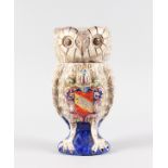 A GOOD TIN GLAZE OWL TOBACCO JAR with removable head, on a blue base. 10ins high.