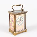 A SMALL BRASS CARRIAGE CLOCK, with pink ground Sevres style panels. 4.25ins high.