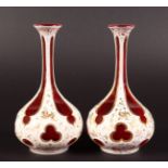 A PAIR OF BOHEMIAN PINK AND WHITE OVERLAY BOTTLE VASES with gilt decoration. 6.25ins high.