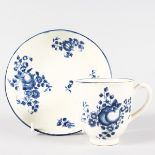 AN 18TH CENTURY WORCESTER COFFEE CUP AND SAUCER printed with sprigs of fruit in underglaze blue.