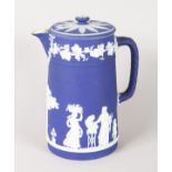 A WEDGWOOD BLUE AND WHITE JASPER WARE JUG AND COVER. 8ins high.