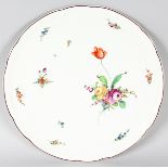 A CONTINENTAL PORCELAIN CIRCULAR SERVING DISH painted with flowers. 14ins diameter.