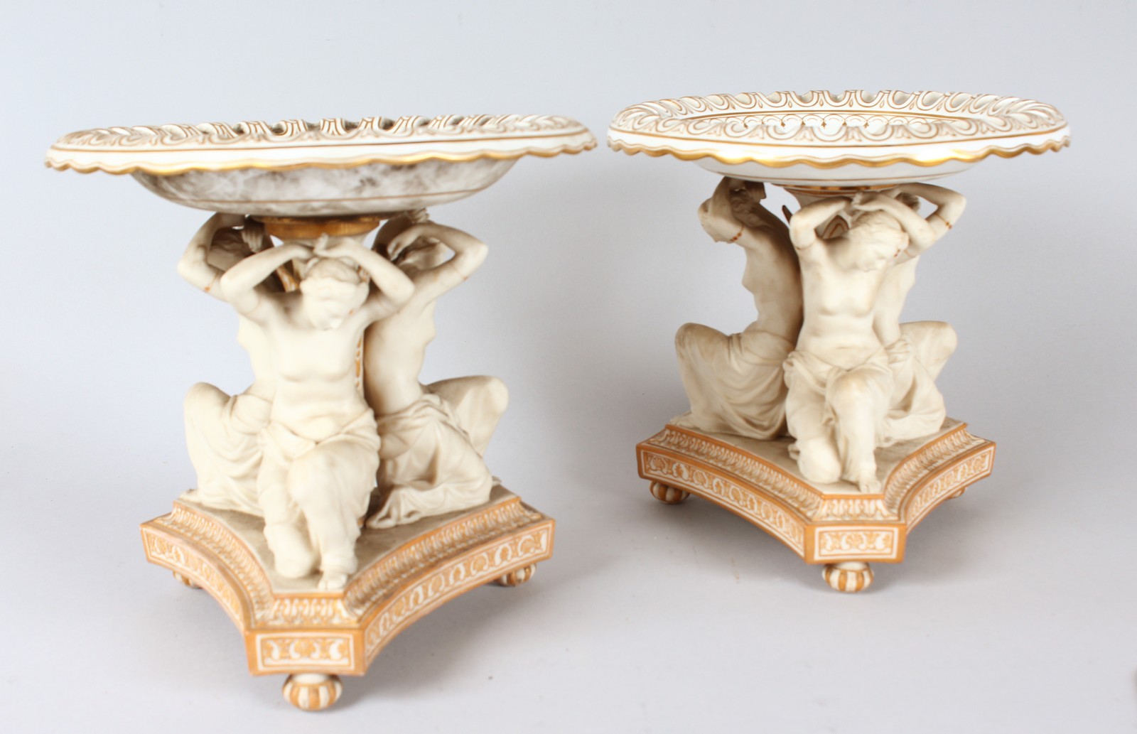 A PAIR OF COPELAND PORCELAIN CIRCULAR COMPORTS with three classical females, supported on a