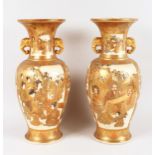 A GOOD LARGE PAIR OF SATSUMA VASES with elephant handles with two main panels of figures and smaller