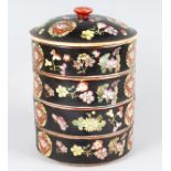 AN ORIENTAL PORCELAIN FOUR TIER SET OF POTS, black ground painted with flowers. 11ins high.