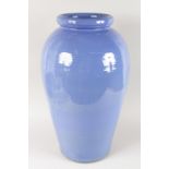 A LARGE BLUE POTTERY VASE. 2ft 1ins high.