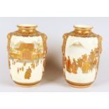 A GOOD PAIR OF JAPANESE SATSUMA MELON SHAPED VASES, with lion mask handles and two panels with