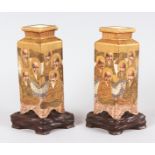 A PAIR OF SATSUMA DIAMOND SHAPED VASES on wooden stands. Vases 6.5ins high.