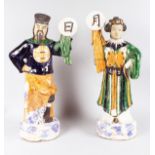 A LARGE PAIR OF CHINESE POTTERY FIGURES OF A MAN AND WOMAN carrying symbols. 25ins high.