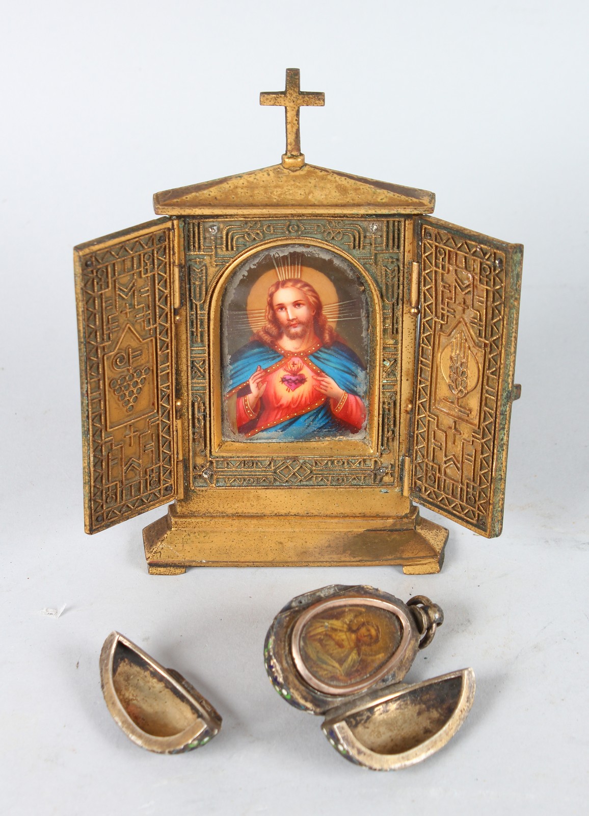 A SMALL CONTINENTAL BRONZE AND PORCELAIN FOLDING TRIPTYCH and A RUSSIAN SILVER AND ENAMEL FOLDING