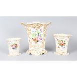 A LARGE AND TWO SMALL FRENCH WHITE GROUND PORCELAIN VASES edged in gilt and painted with flowers.