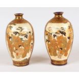 A SMALL PAIR OF JAPANESE BLUE AND GILT SATSUMA VASES with two main panels of figures. Mark in gold