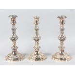 A PAIR OF VICTORIAN PLATED CANDLESTICKS and another similar stick. All 10.5ins high.